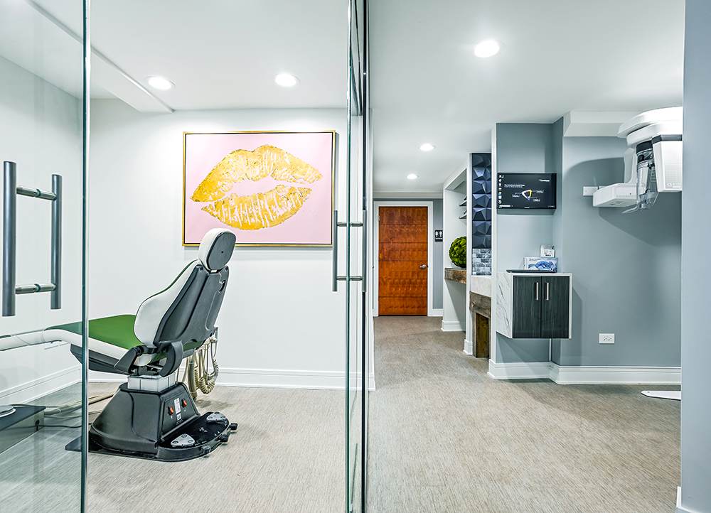 A glass-walled treatment room with natural light.